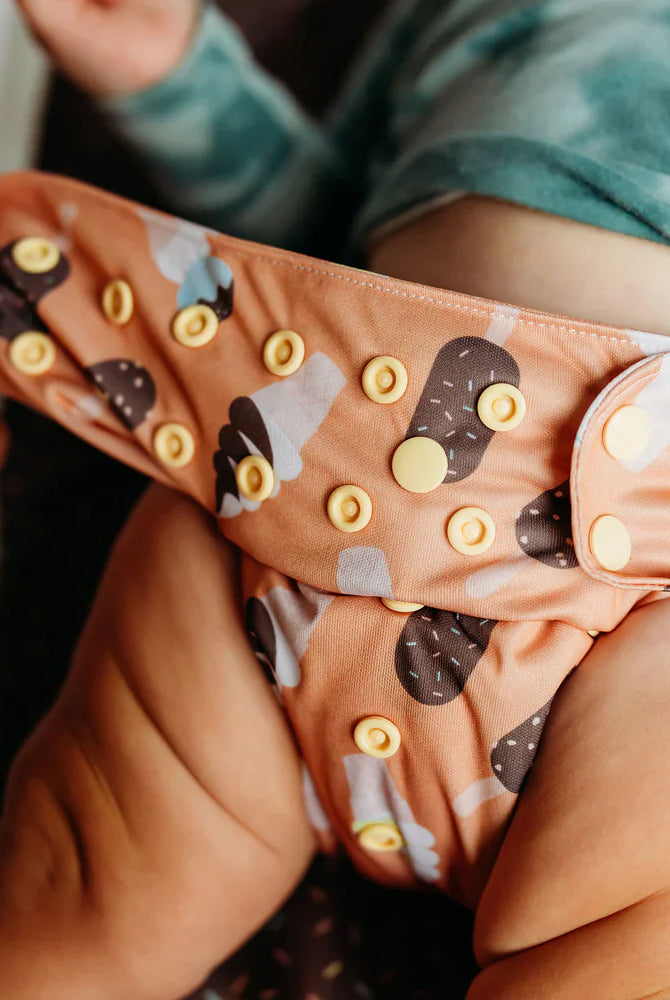 pocket diaper on baby showing snap setting