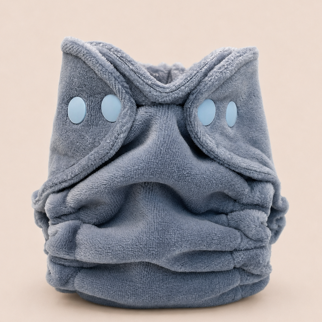 A plush, dusty blue cloth diaper