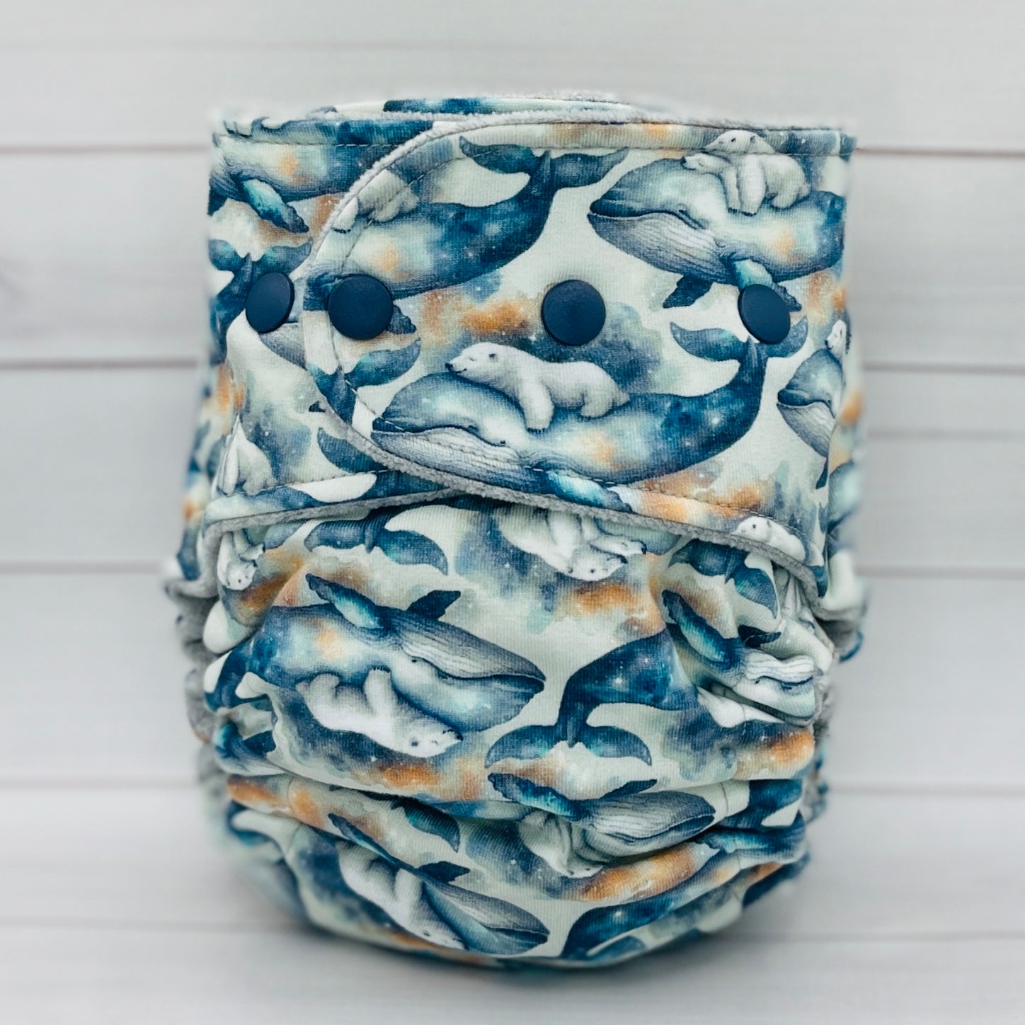 Reusable nappy with whale pattern on a white background