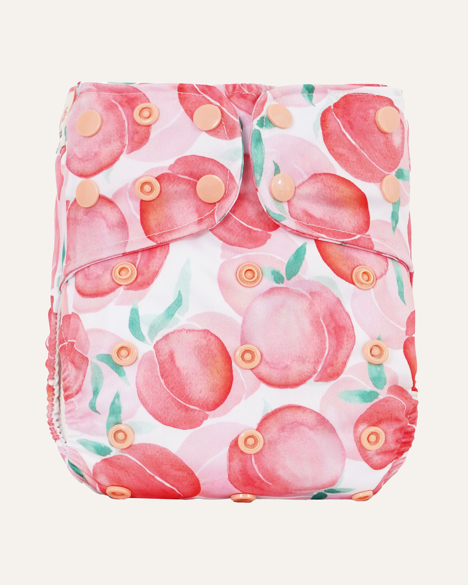 Reusable diaper cover with pink peach pattern on a white background