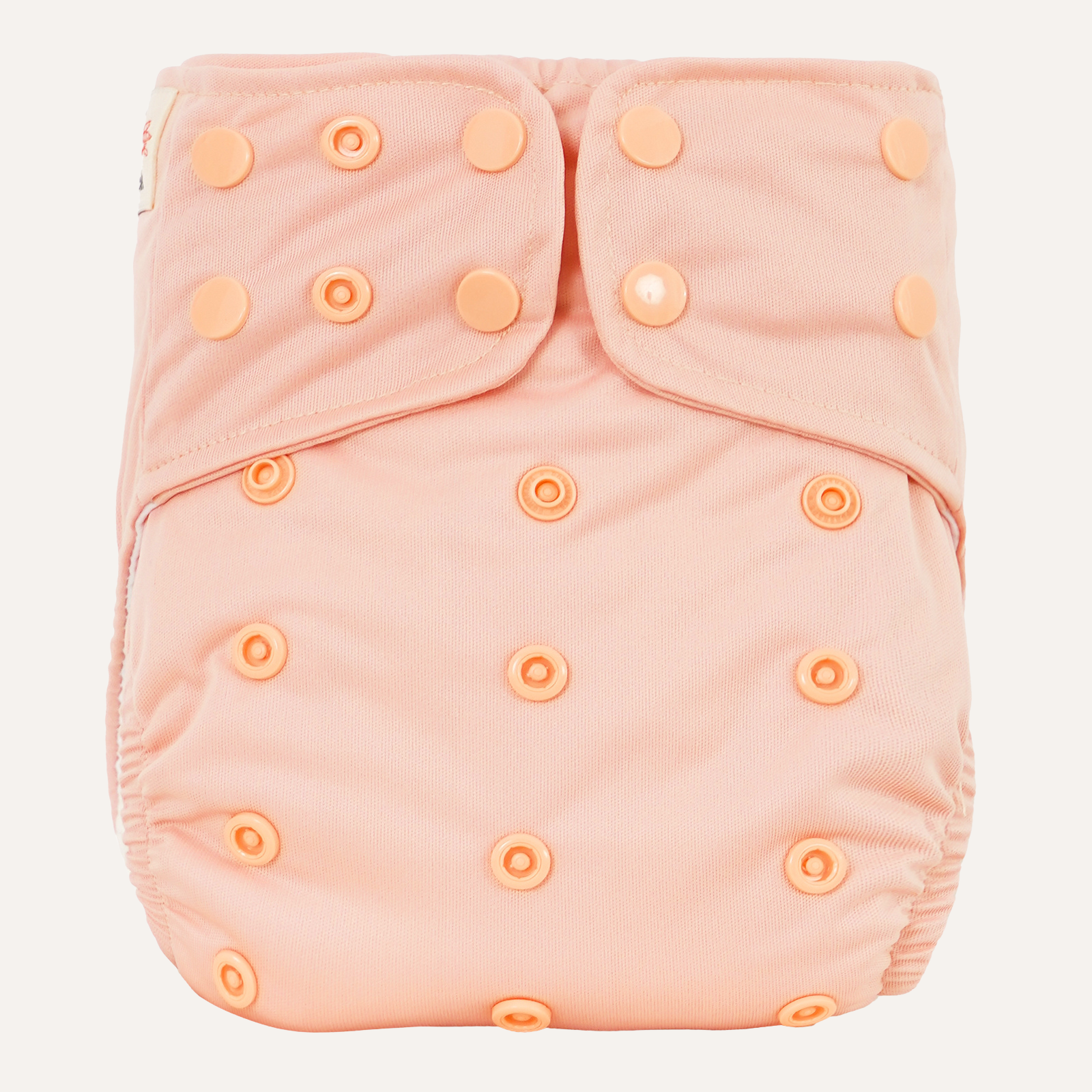 Pink cloth diaper cover with button closures on a light gray background
