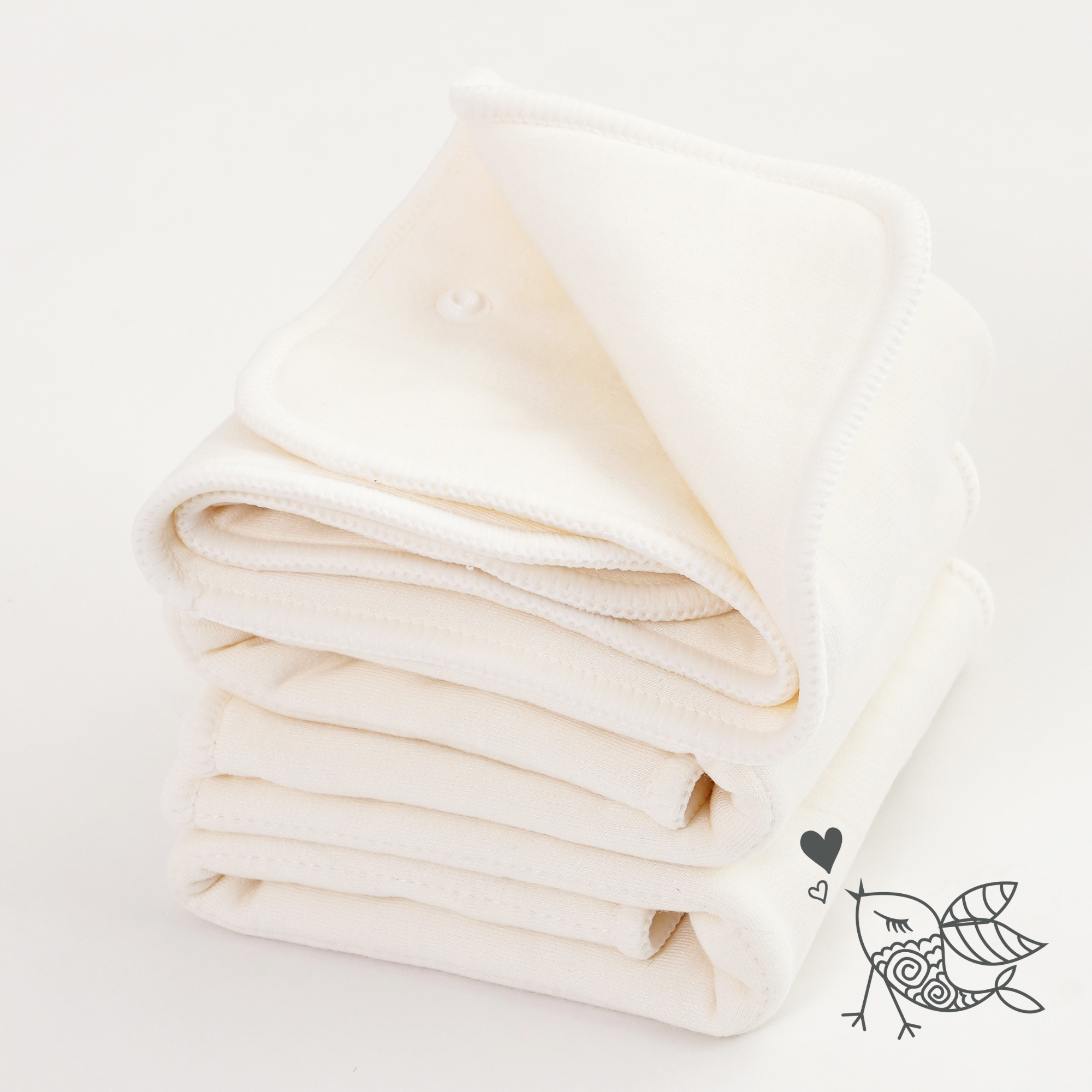 Folded beige cloth diaper inserts on a light background with a small logo in the corner.