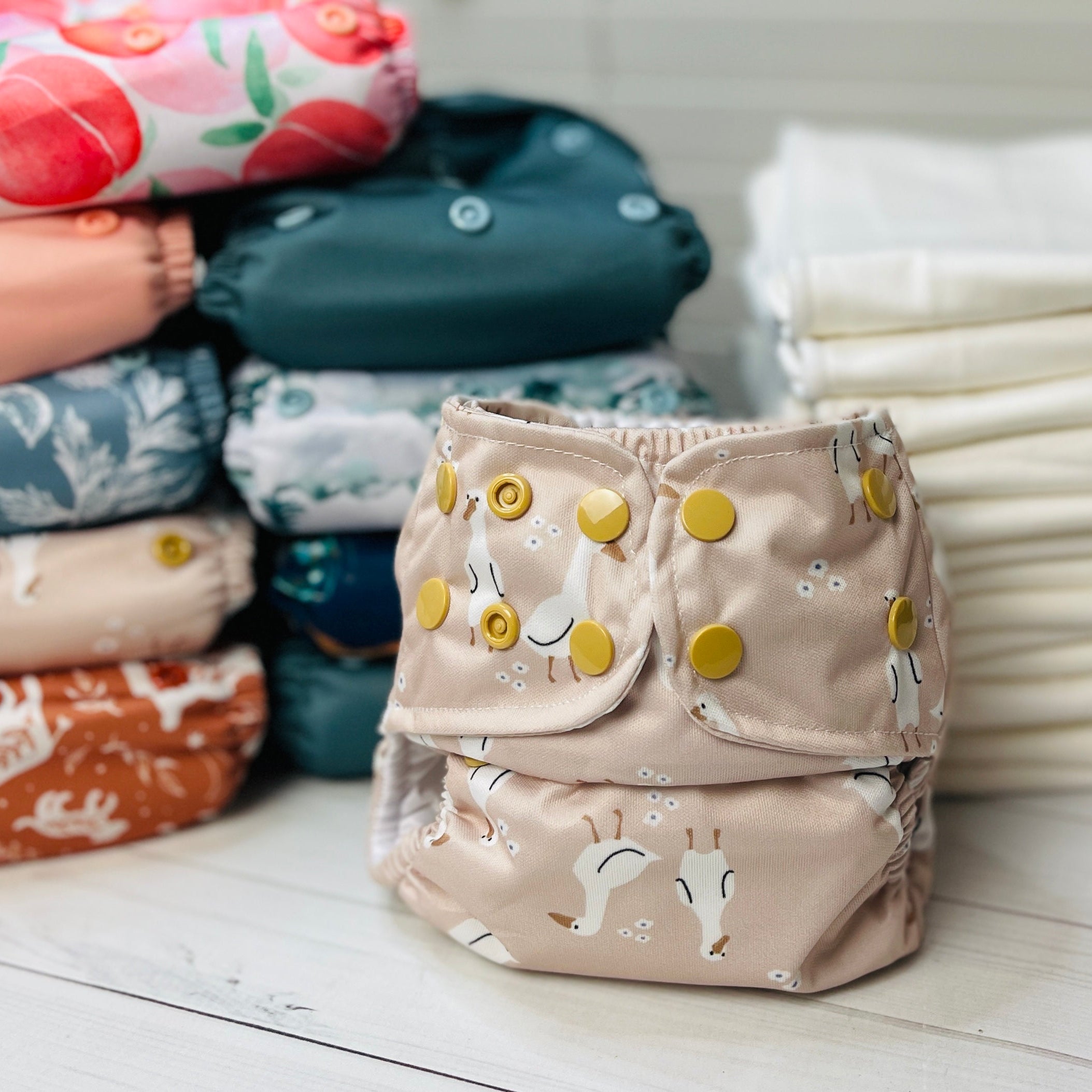 mix print all in two cloth diapers folded on a table with inserts