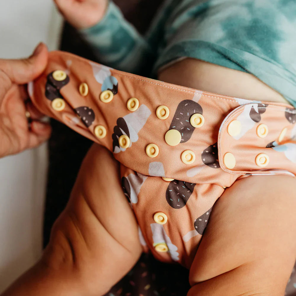 pocket diaper on baby showing snap setting