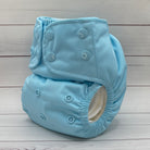 Light blue cloth diaper on a wooden surface