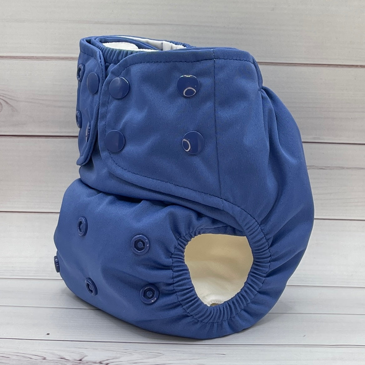 Blue cloth diaper on a wooden surface