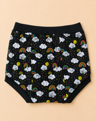 Black diaper cover with a playful cloud, rainbow, and sun print, laid flat on a solid beige background.