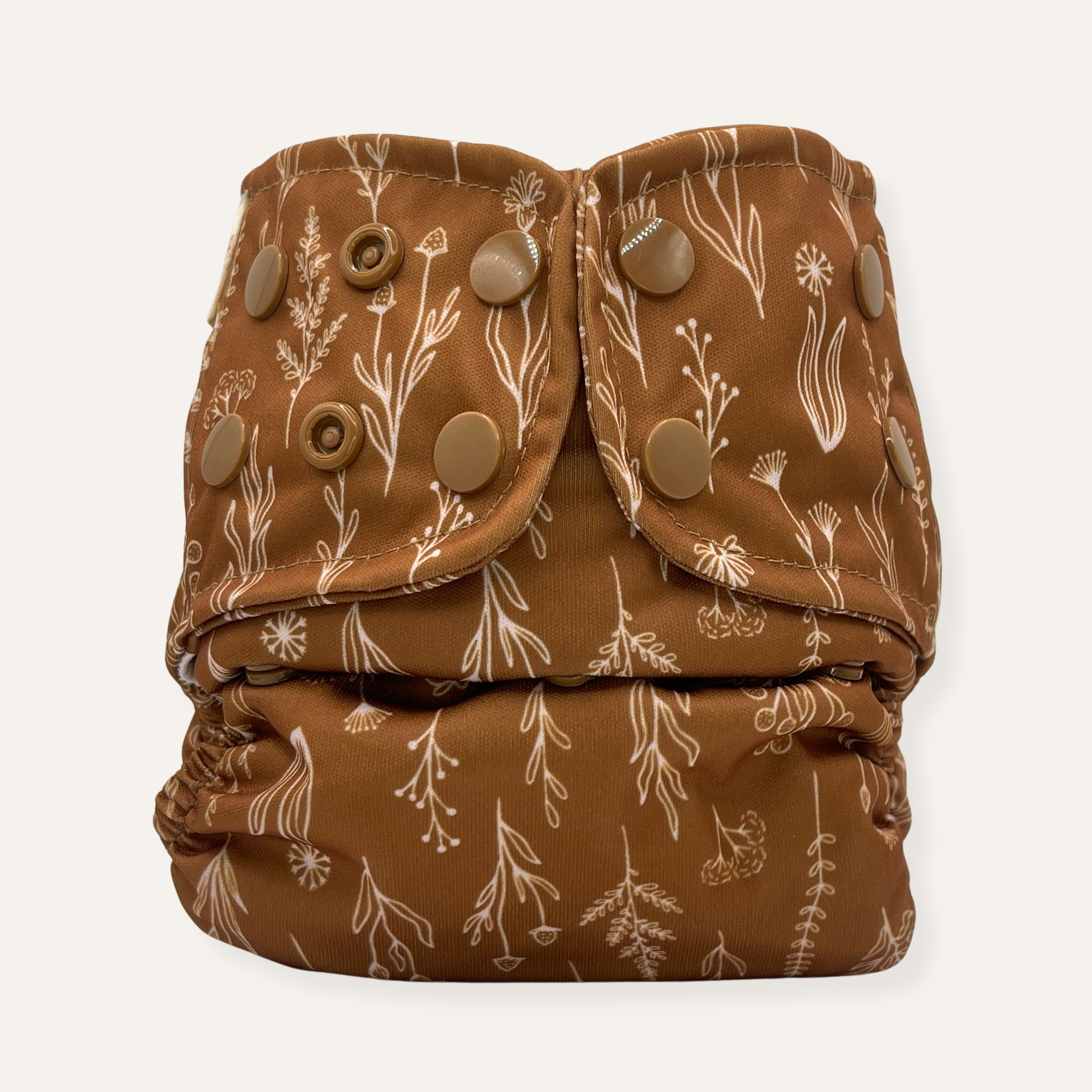 Brown cloth diaper with floral pattern on a white background