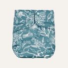 Blue diaper cover with white floral pattern on a white background