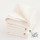 Folded beige cloth diaper inserts on a light background with a small logo in the corner.