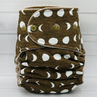 Brown cloth diaper with white moon phases on a light gray background