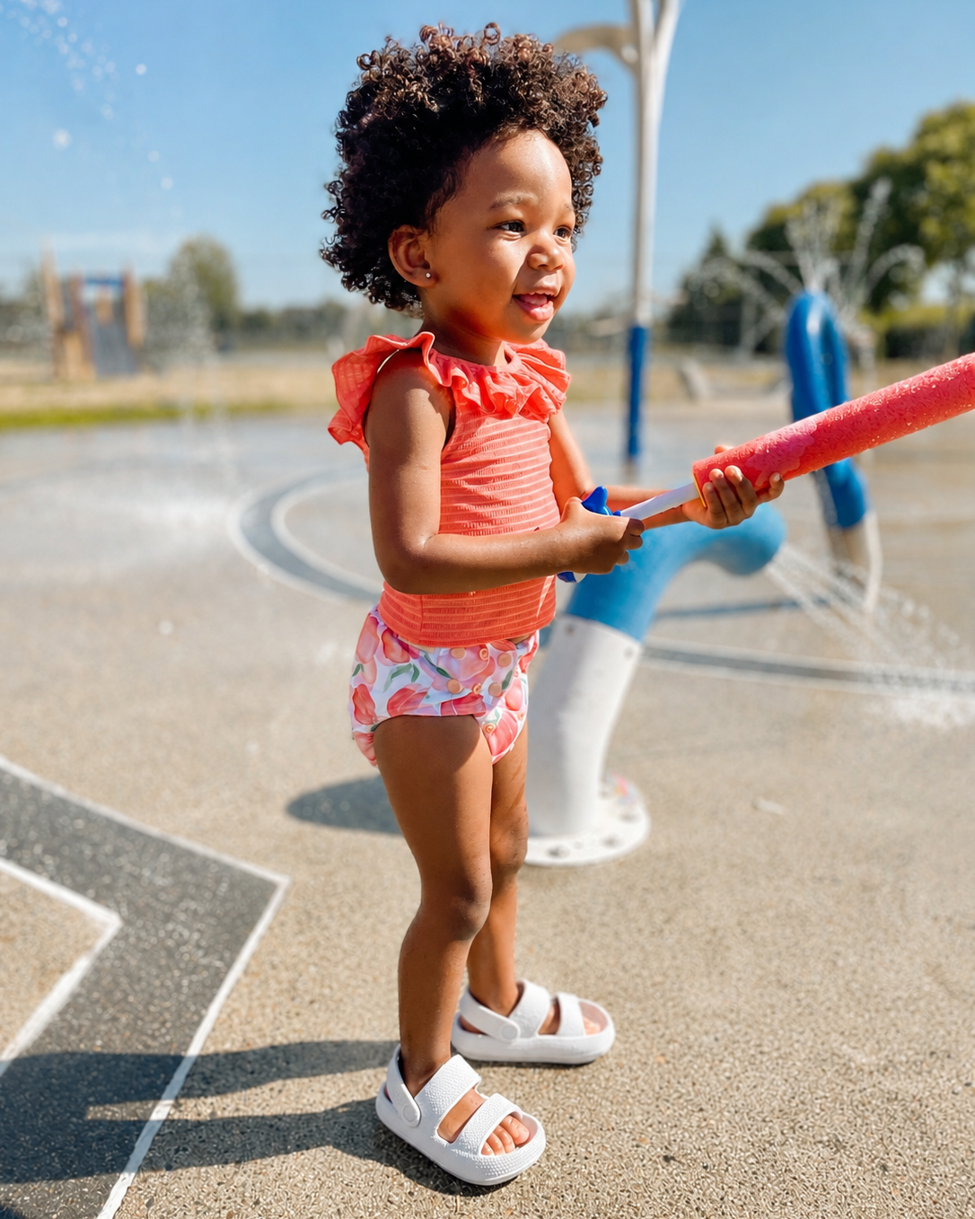 Child playing with a water toy at a playground