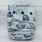 Rainbow patterned cloth diaper on a light wooden background