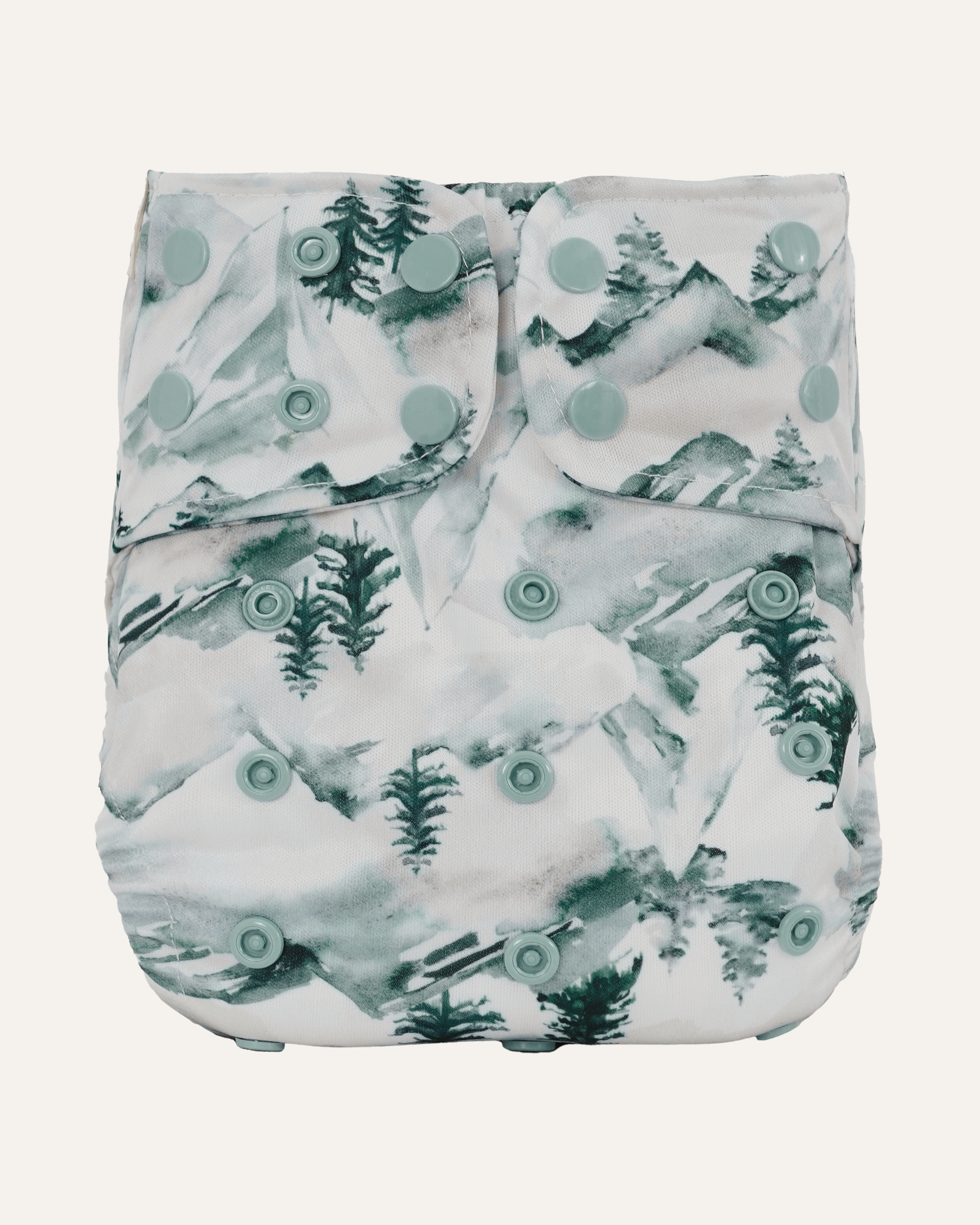 Patterned diaper with green trees and circles on a white background