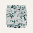 Patterned diaper with green trees and circles on a white background