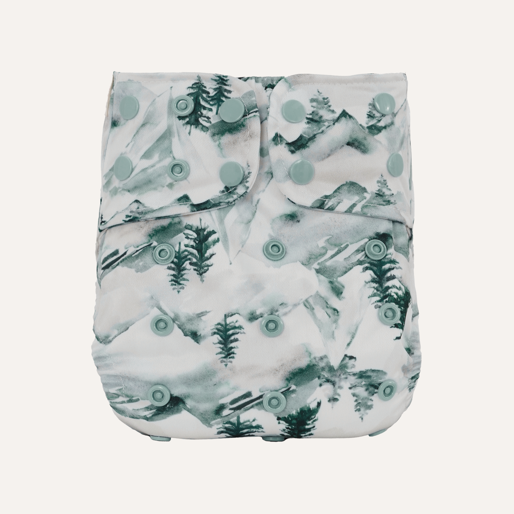 Patterned diaper with green trees and circles on a white background