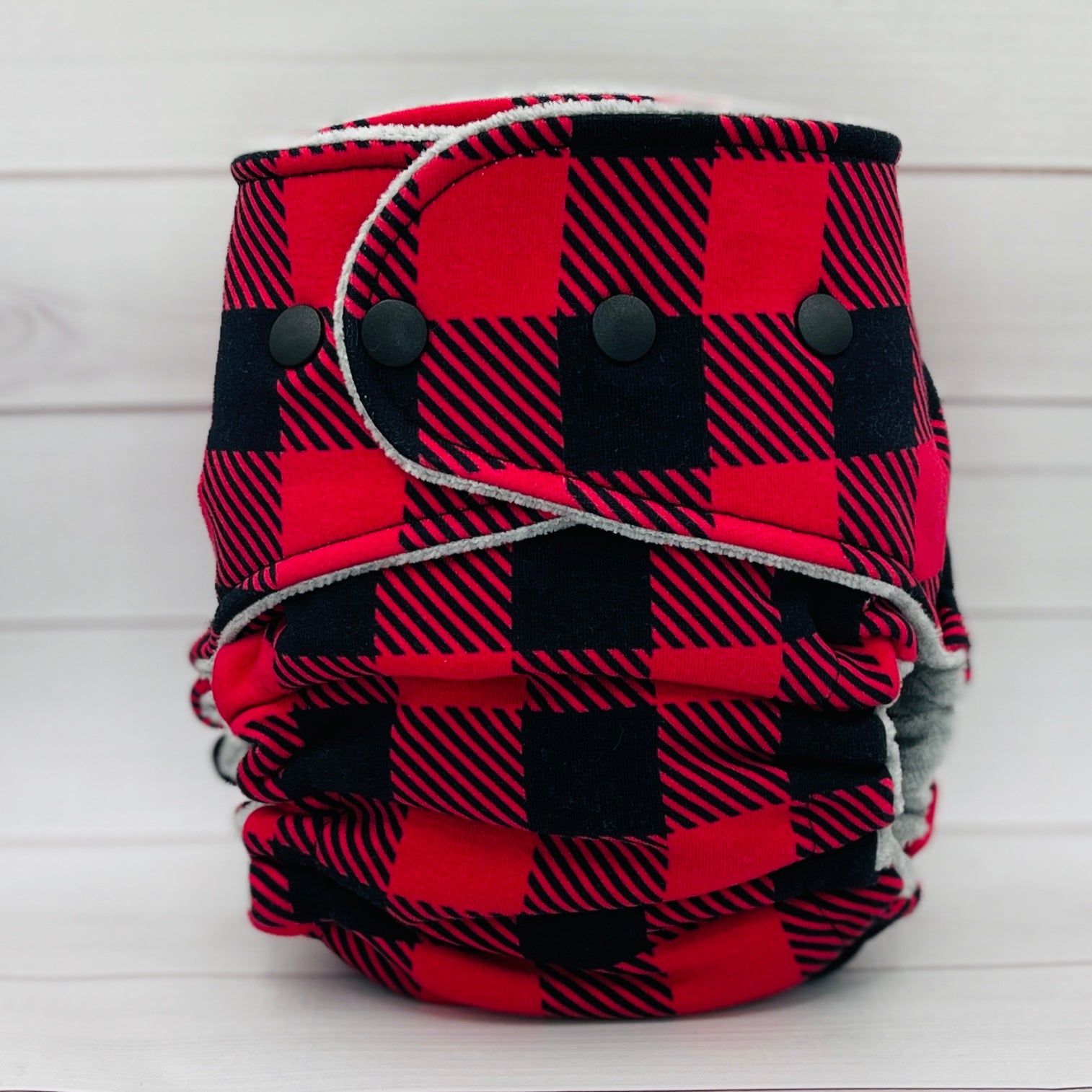 Red and black plaid diaper on a white background