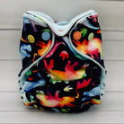 Colorful dinosaur-patterned cloth diaper on a wooden surface