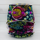 Floral patterned diaper with colorful buttons on a white background