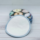 Reusable nursing pads with a donut pattern on a wooden surface