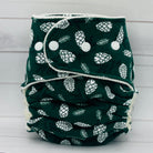 one size fitted diaper with dark green print and white pinecones