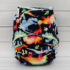 Colorful dinosaur-patterned cloth diaper on a wooden surface