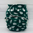 petite fitted diaper with dark green print and white pinecones