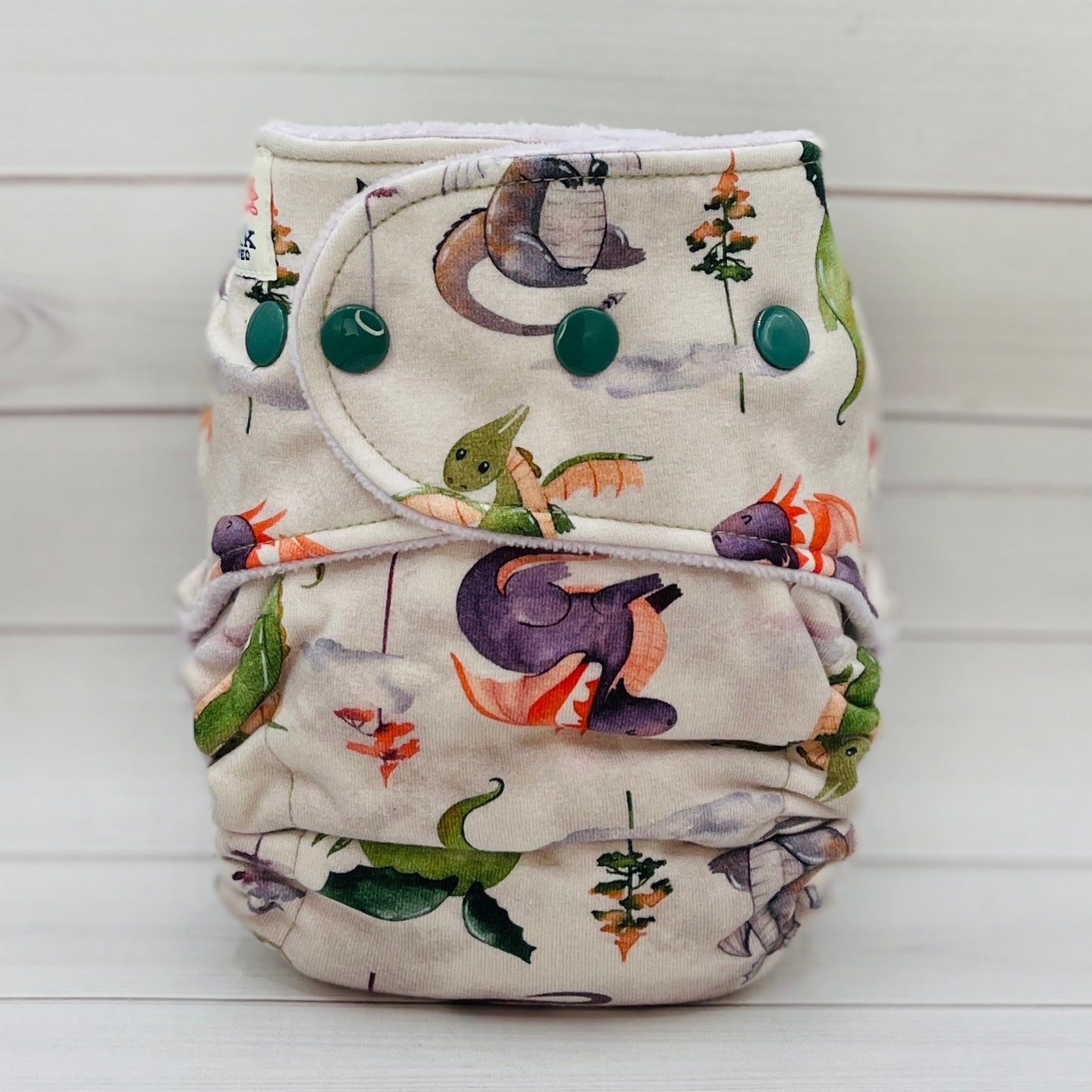 Patterned cloth diaper on a white wooden background