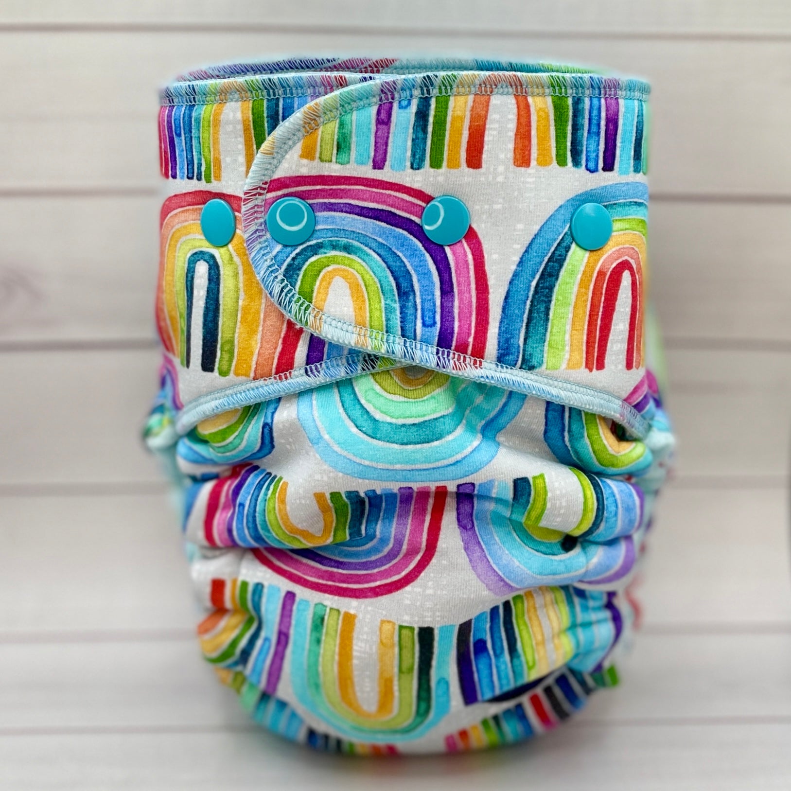 rainbow cloth diaper on wood table