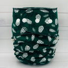 toddler fitted diaper with dark green print and white pinecones