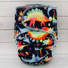 Colorful dinosaur-patterned cloth diaper on a wooden surface