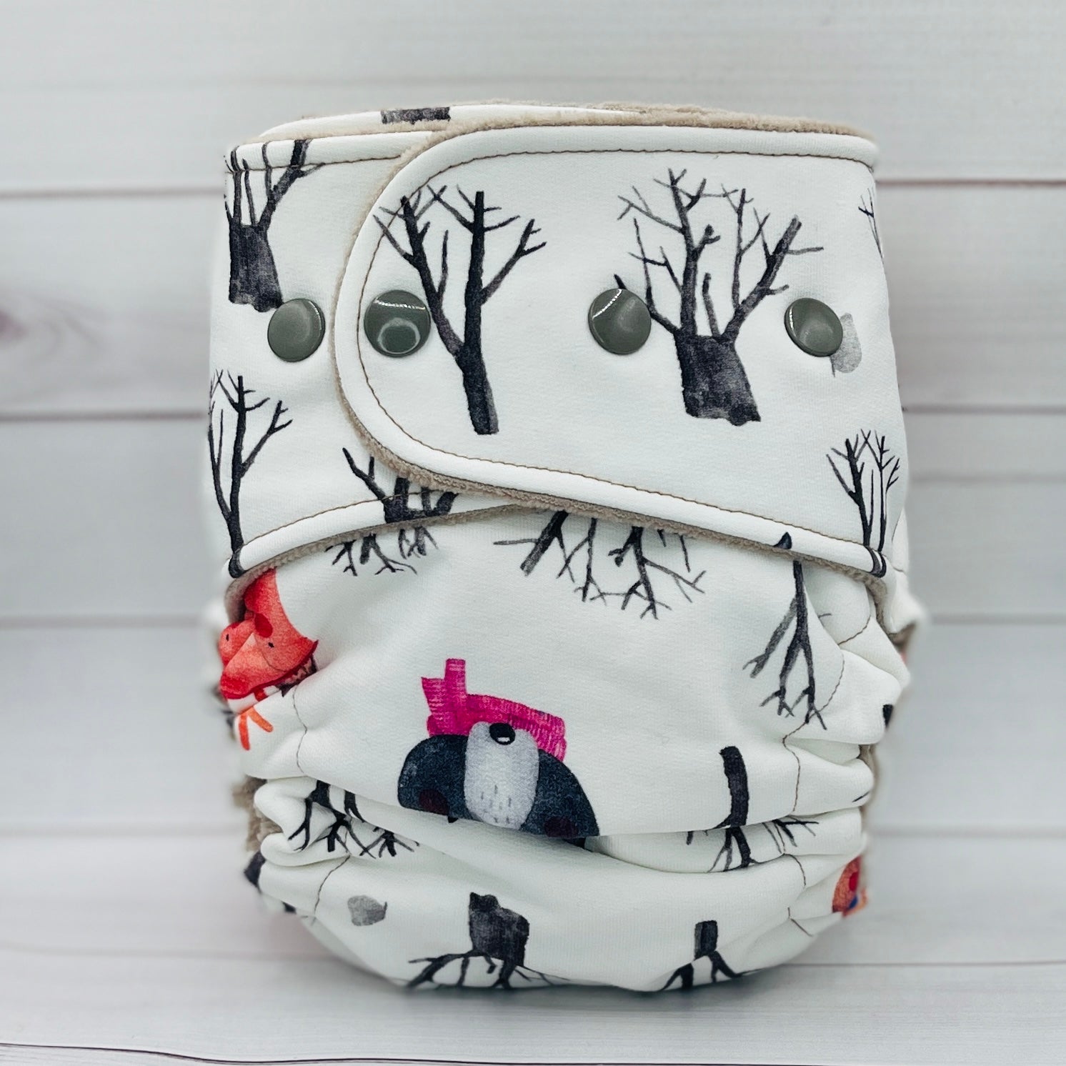 Patterned diaper cover with tree design on a white background