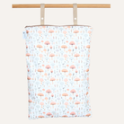 Fabric with mushroom pattern hanging on a wooden rod against a white background